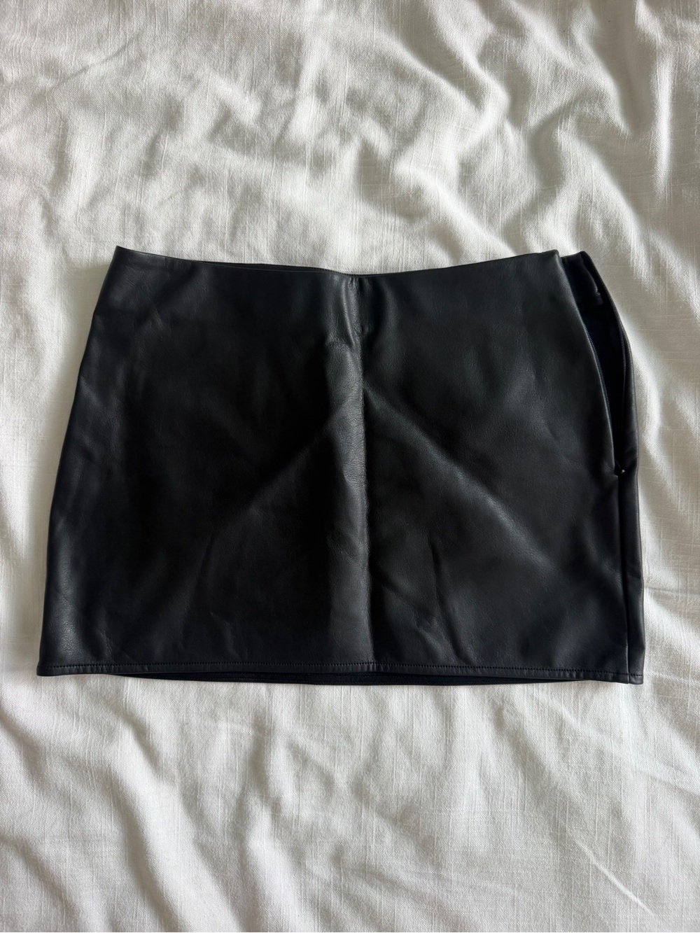 Uniform person black leather skirt